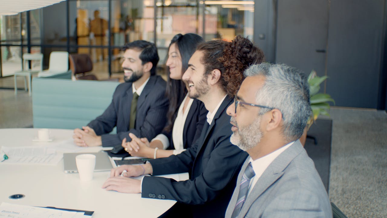 A diverse group of professionals engaged in a meeting inside a modern office.